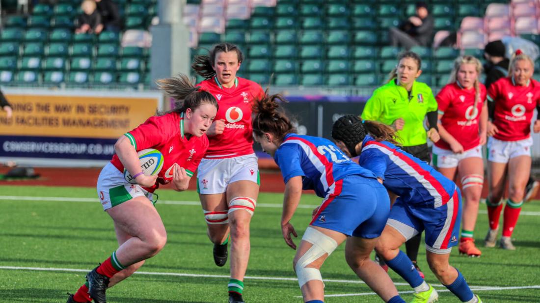 Female rugby players in action on the pitch