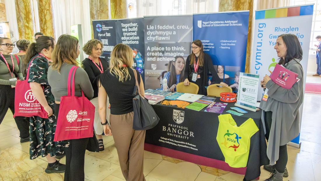 People in front of exhibition at conference