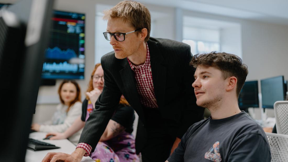 lecturer teaching students in computer lab