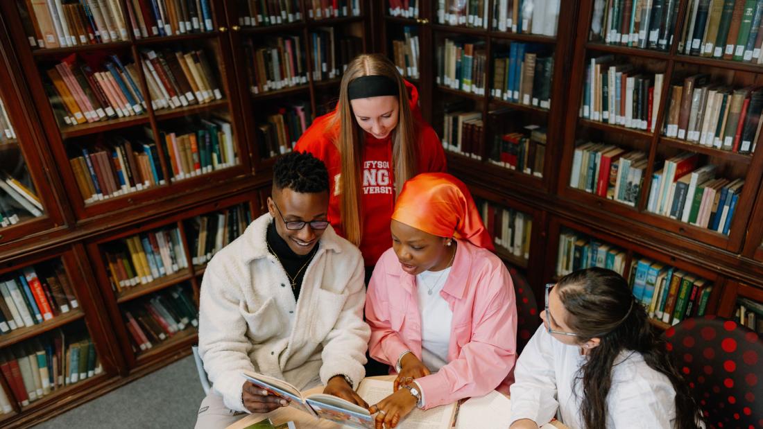 students studying history books in library