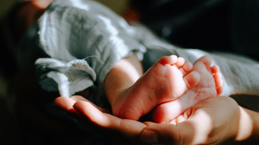 an image of a person holding a baby 