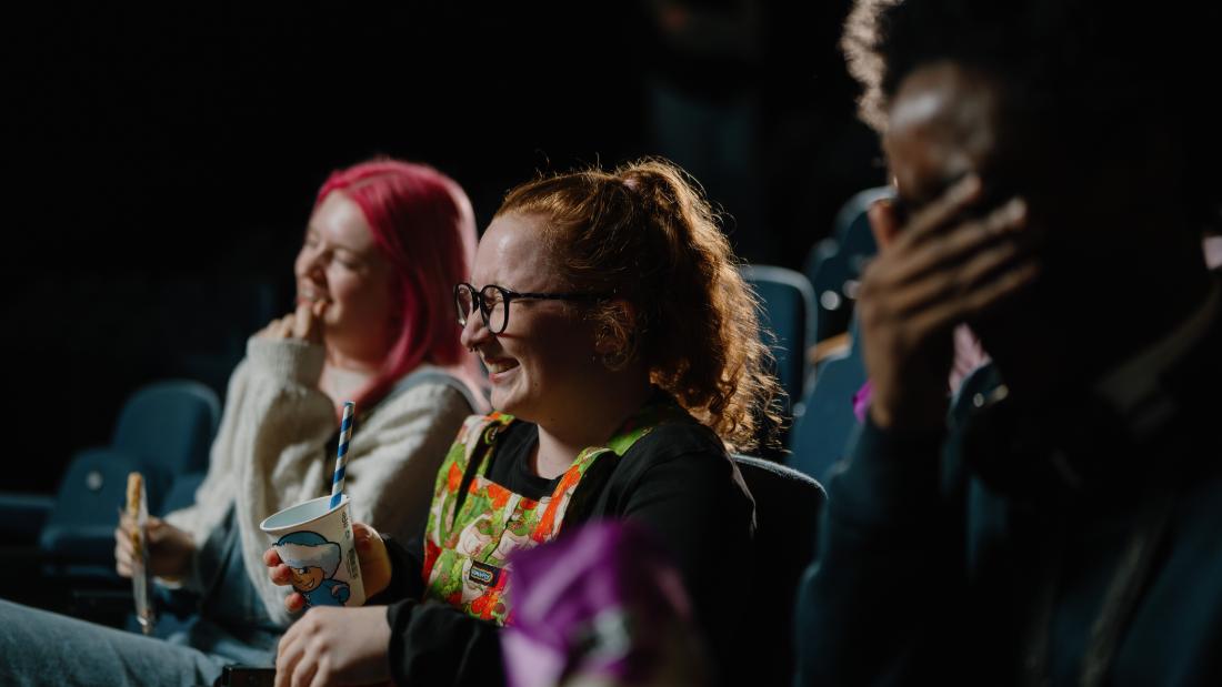 A group of students sitting down in the cinema in Pontio and watching a film