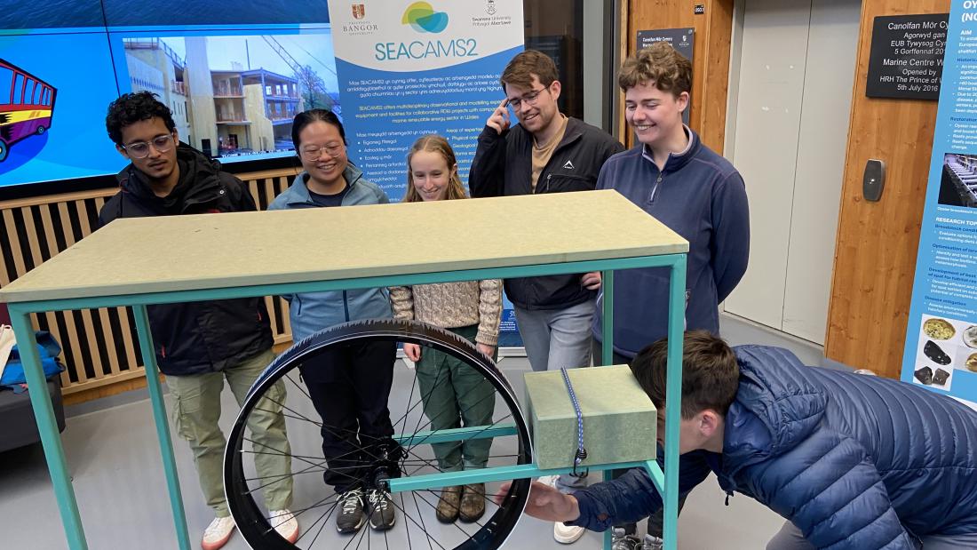 students trying out the wave machine