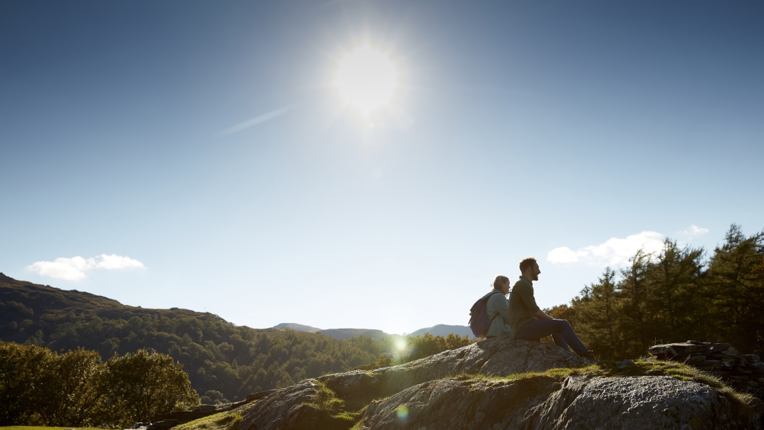 Eryri with two walkers sitting on a rock