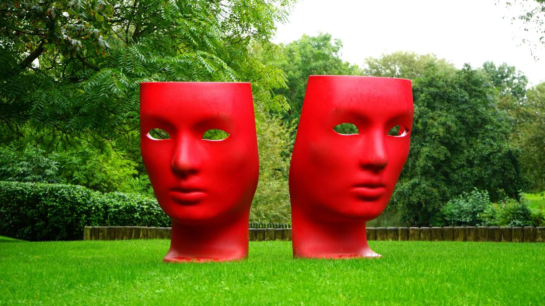 Two Statues of red faces