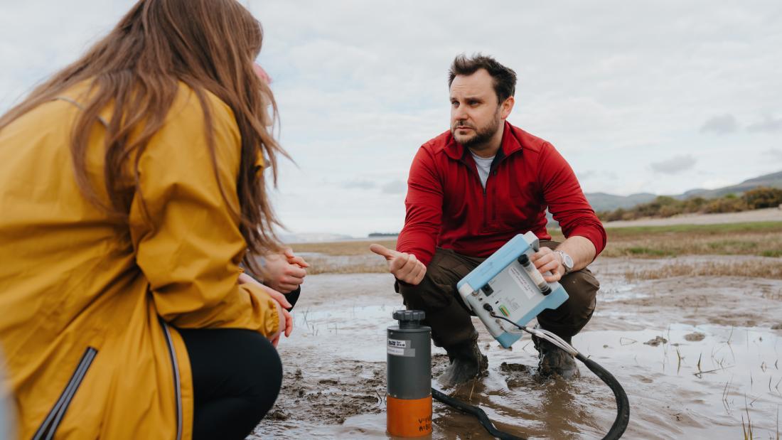 two researcher on a beach