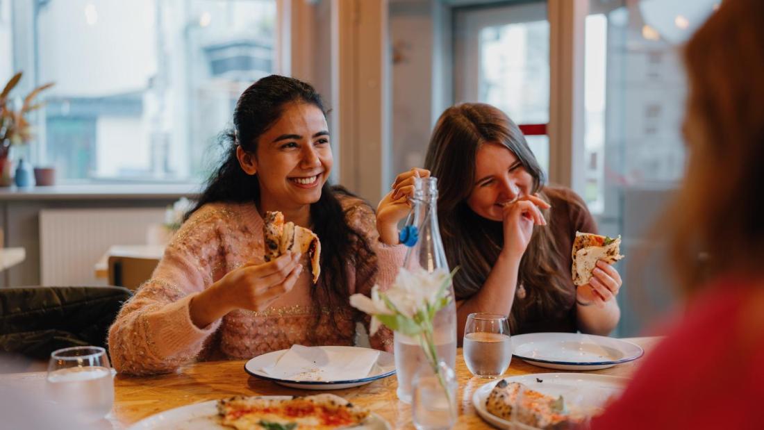 Students chatting and laughing over a meal
