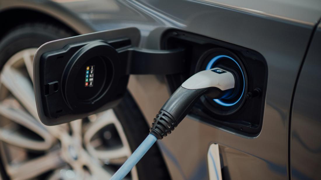 electric car charging with focus on the plug