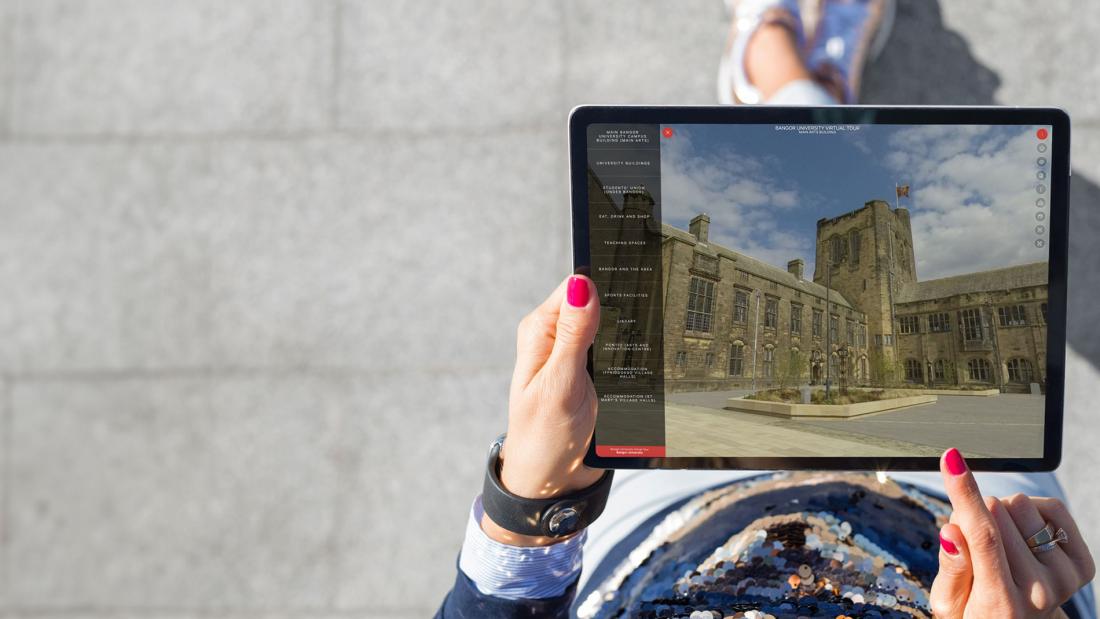 Mockup of student using Virtual Tour on an ipad whilst exploring the site