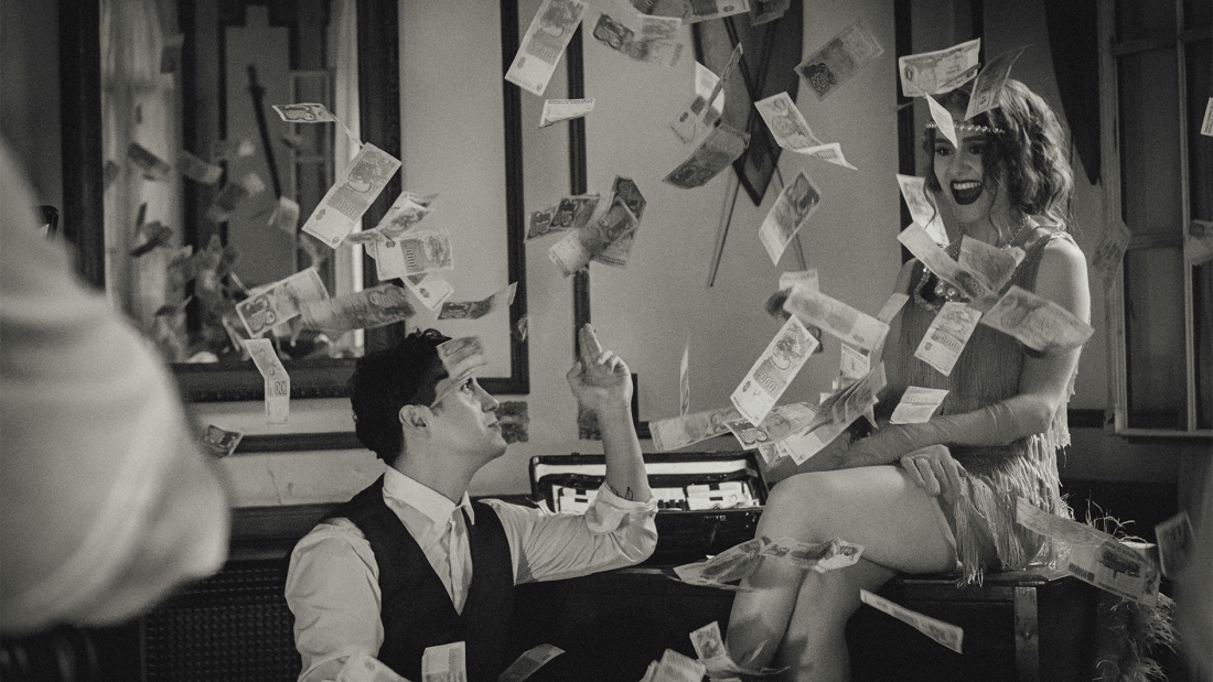 Image of Jazz age lady and man with money in the air