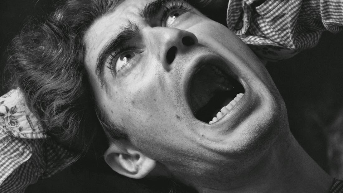 Black and white image of an individual panicking 