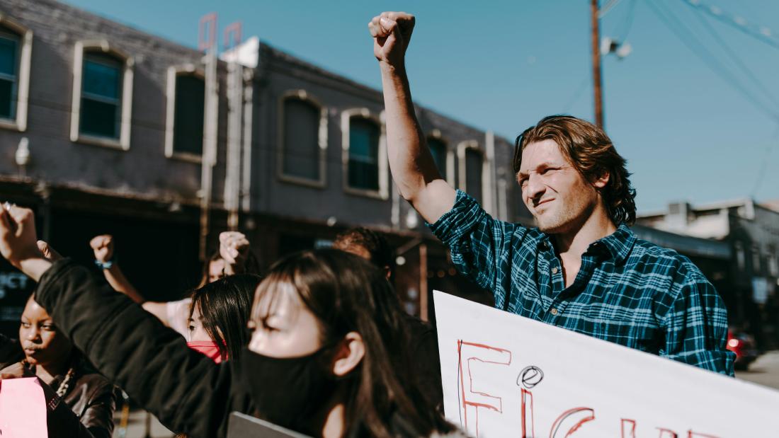 Image of individuals protesting in the open air