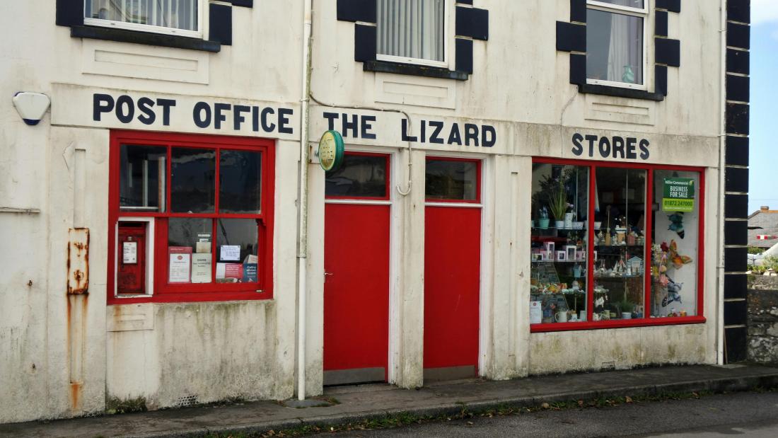 Image of Post Office front, white walls and red door