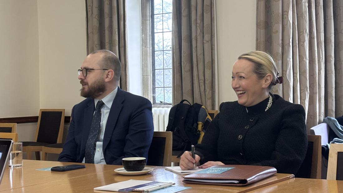 Two Welsh Government ministers sitting by a table 