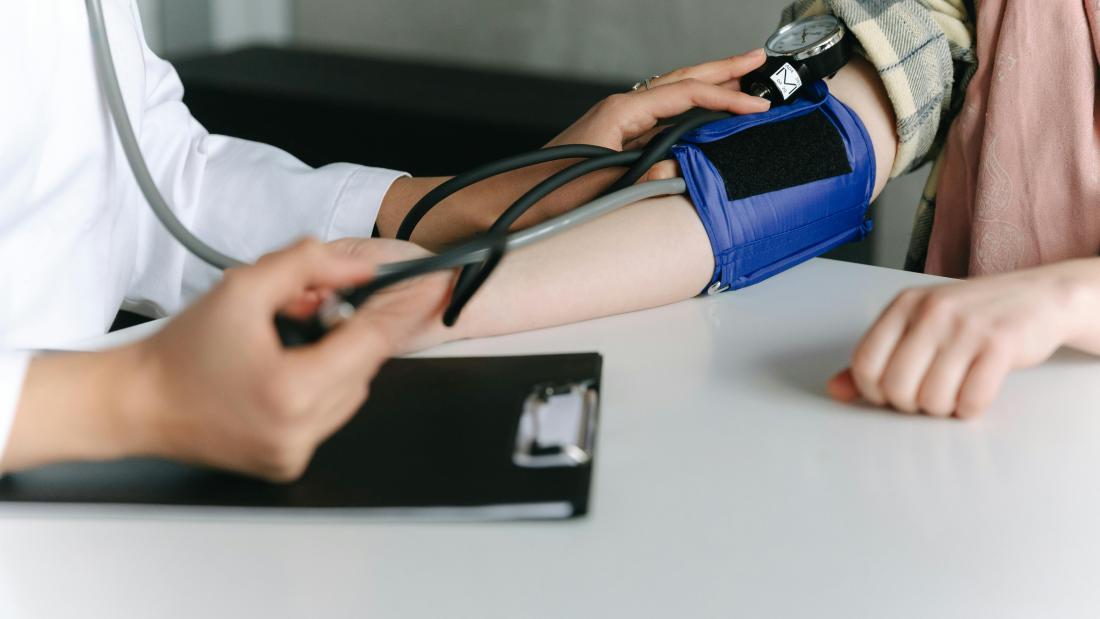 A Healthcare Worker Measuring a Patient's Blood Pressure Using a Sphygmomanometer