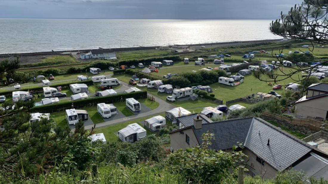 A photo of a caravan site by the sea