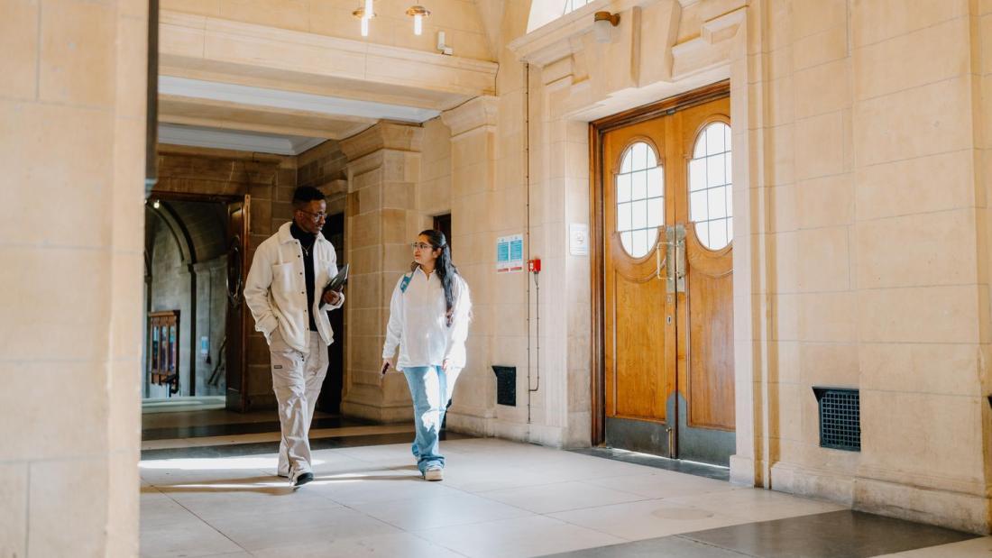 Students walking and chatting in the Main Arts building