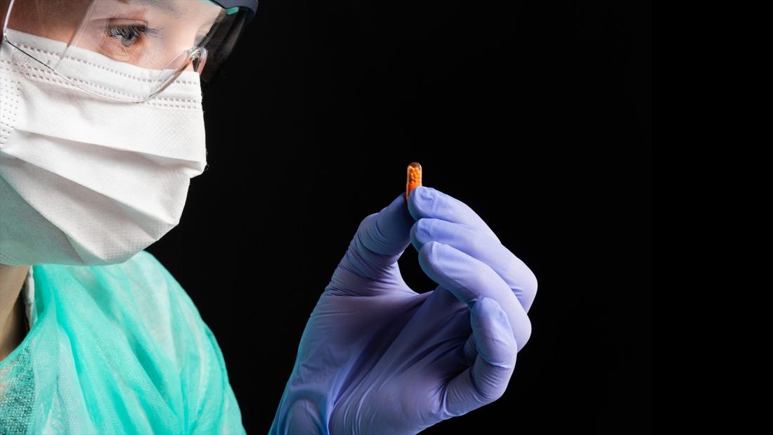 Pharmacist holding a pill