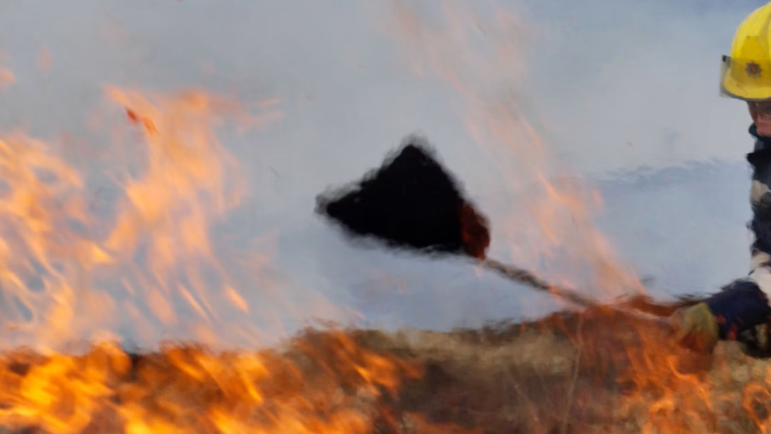A firefighter tackling a blaze