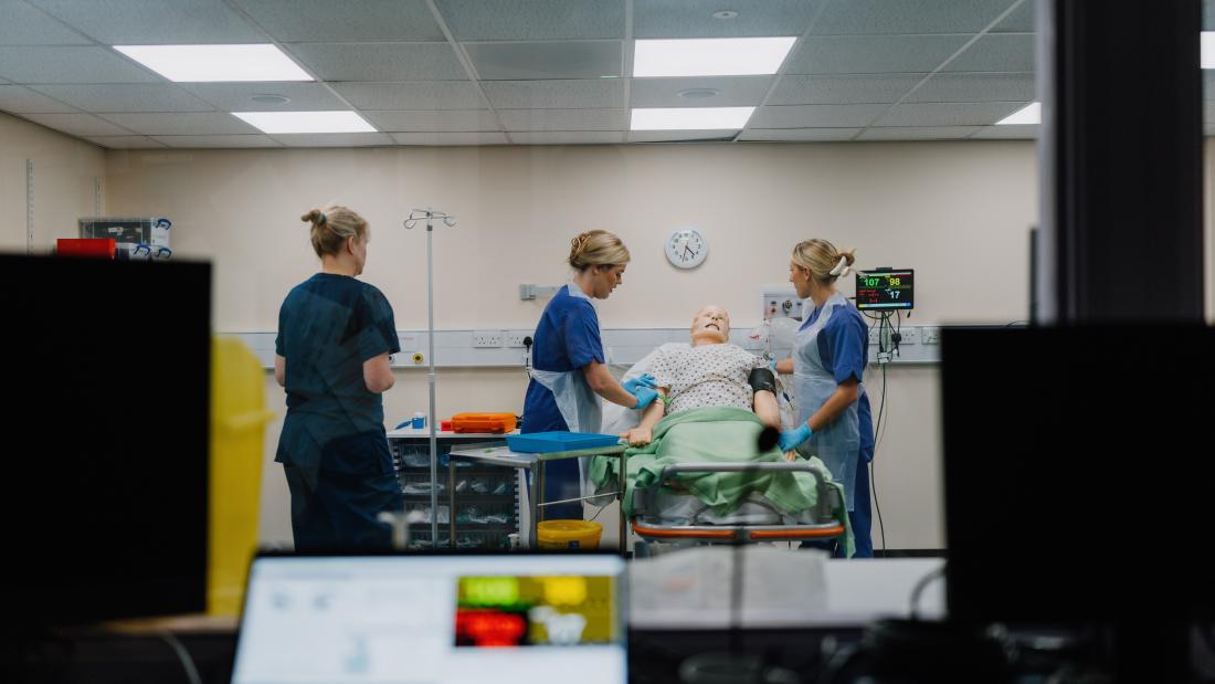 Nursing Students in Clinical Skills Ward working with mannequin