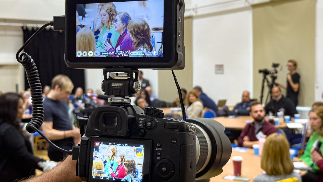 Photo of an audience through a camera lens