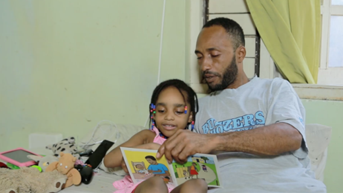 Man reads with his child.png