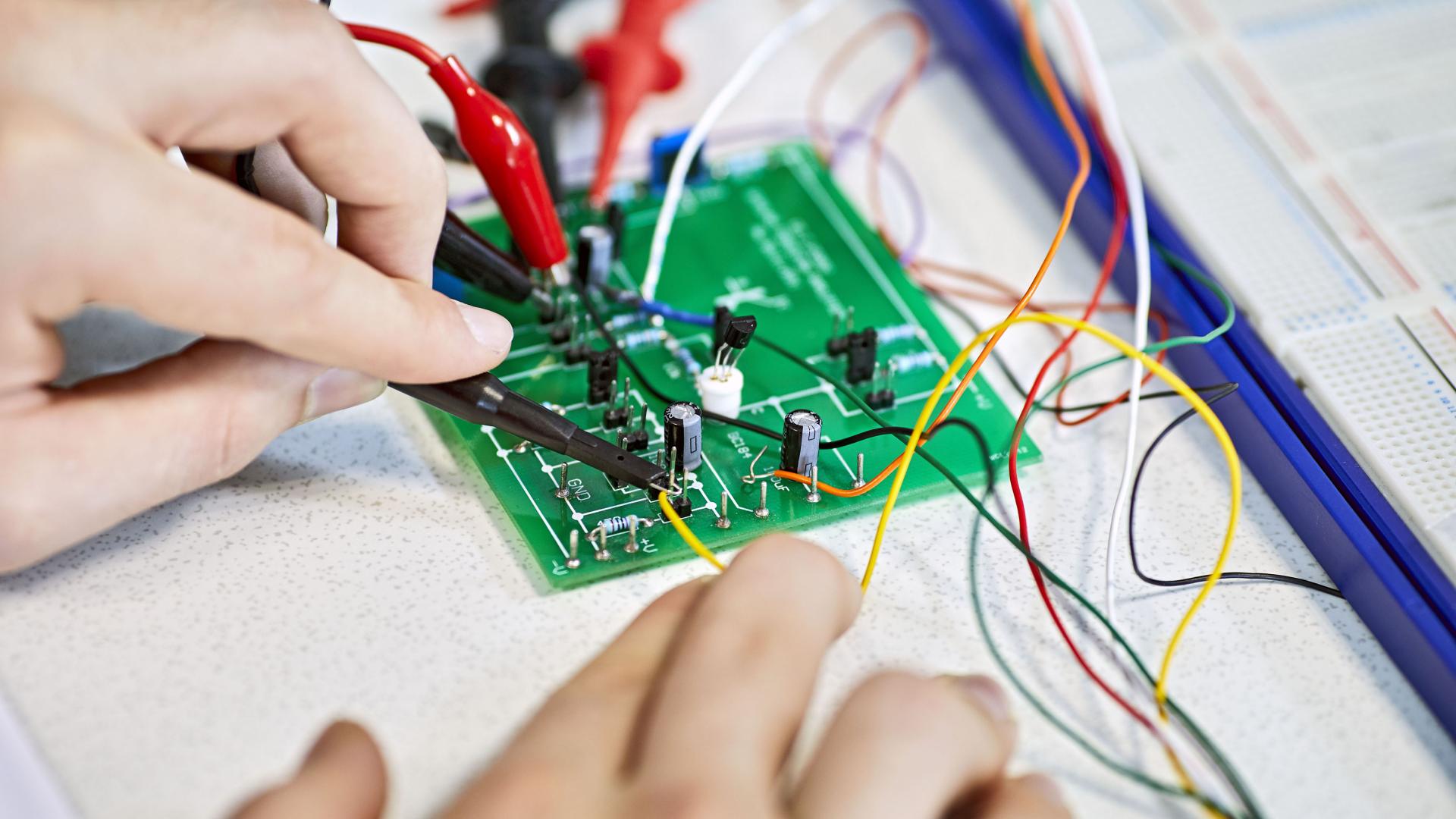 Close-up of a person working on a electrical circuit