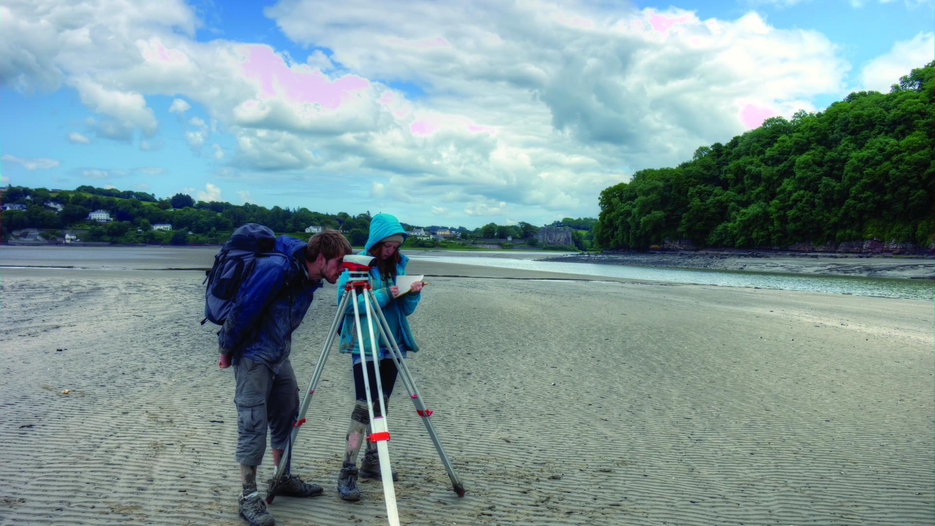 Students conducting surveys on the beach