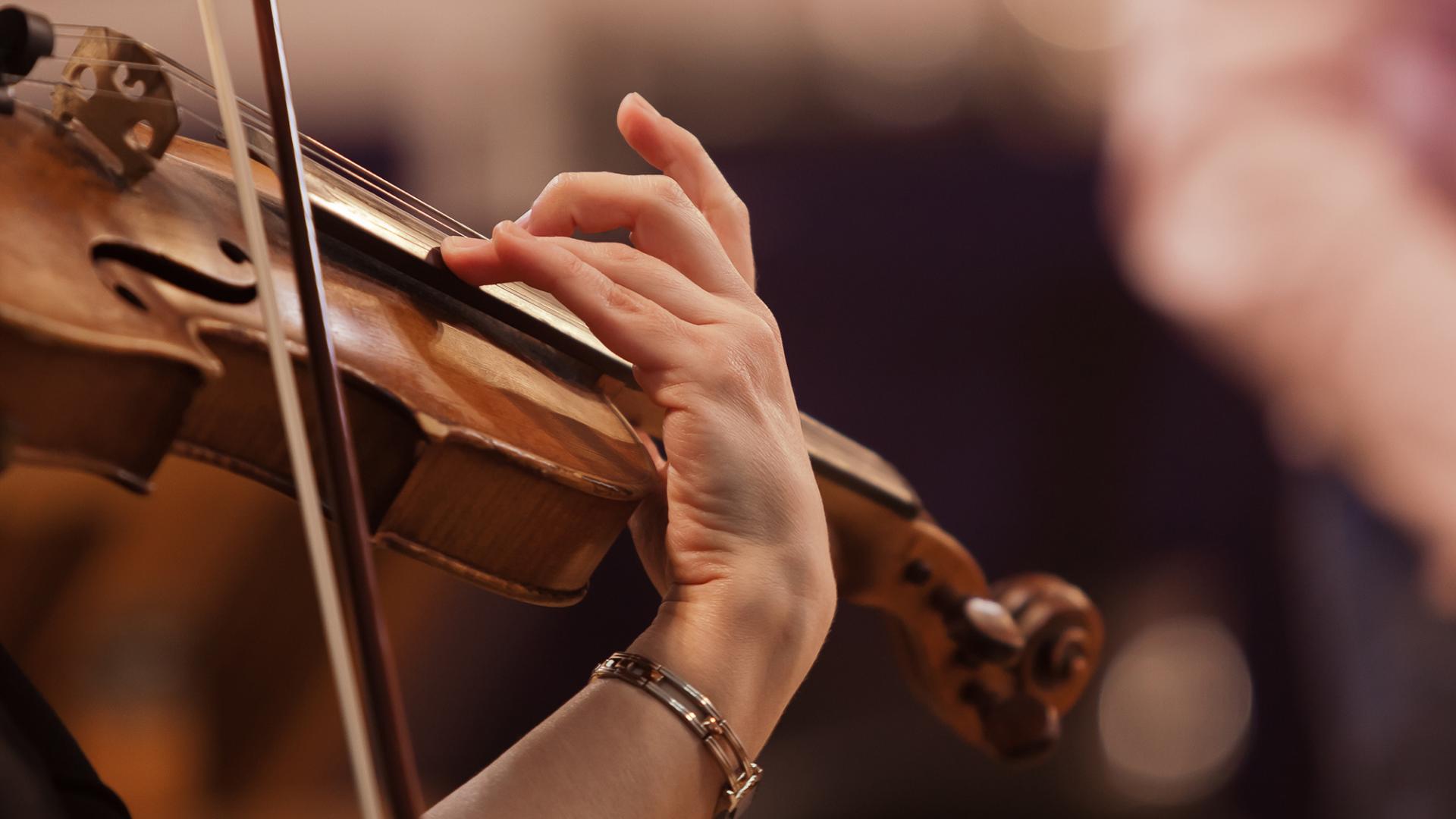 Close-up of a violin being played