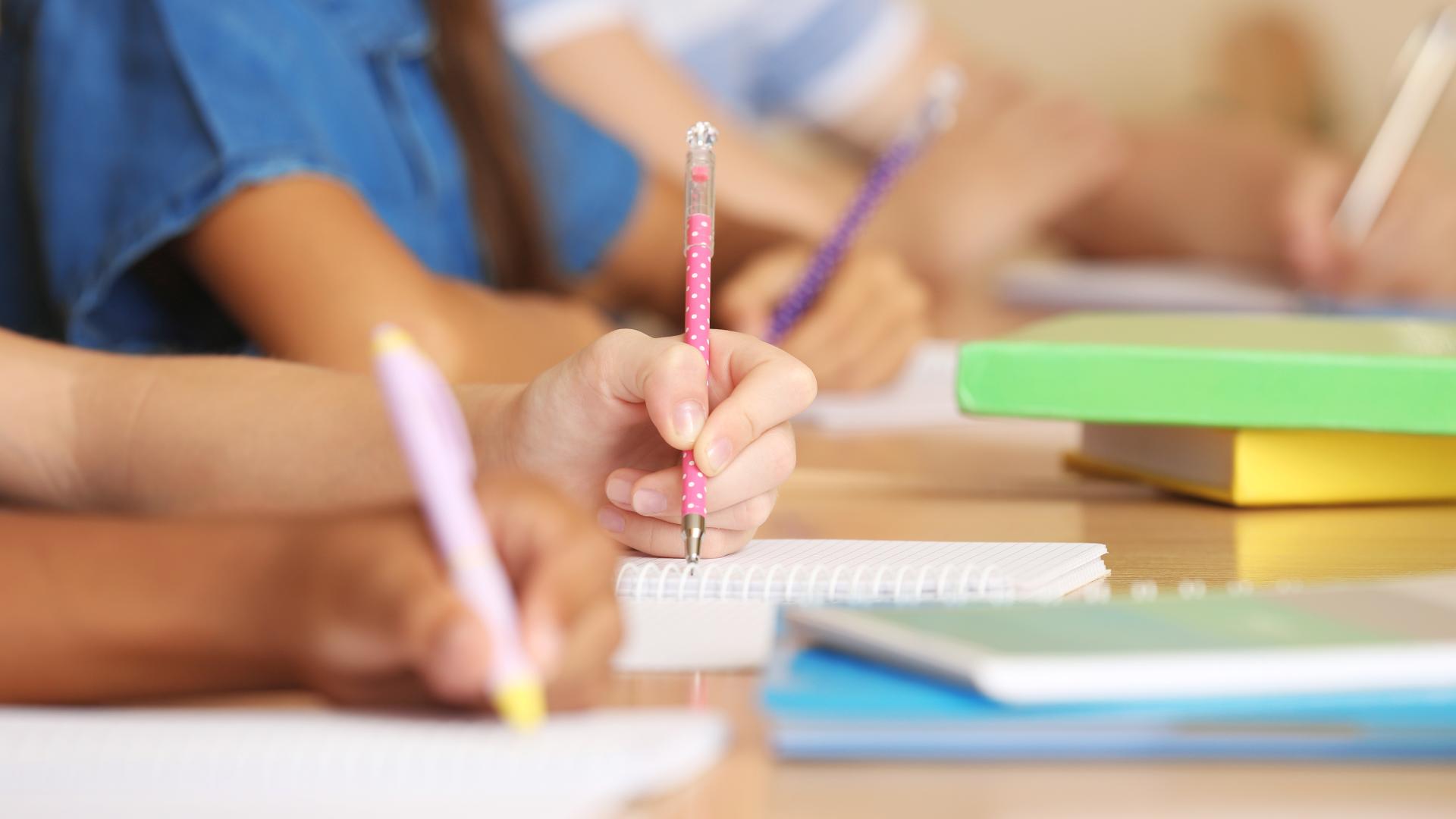 Children writing in classroom 