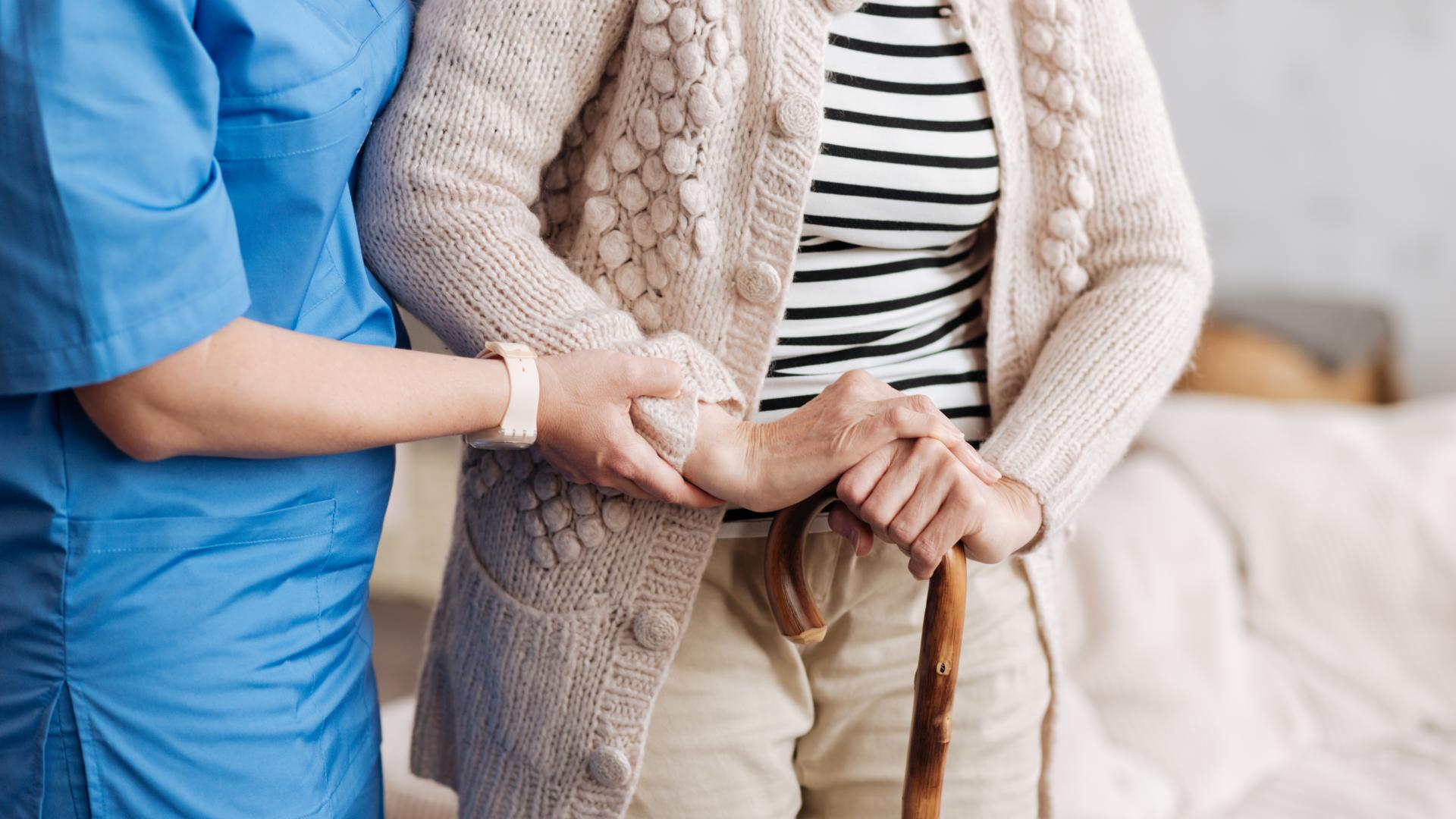 Nurse helping elderly lady