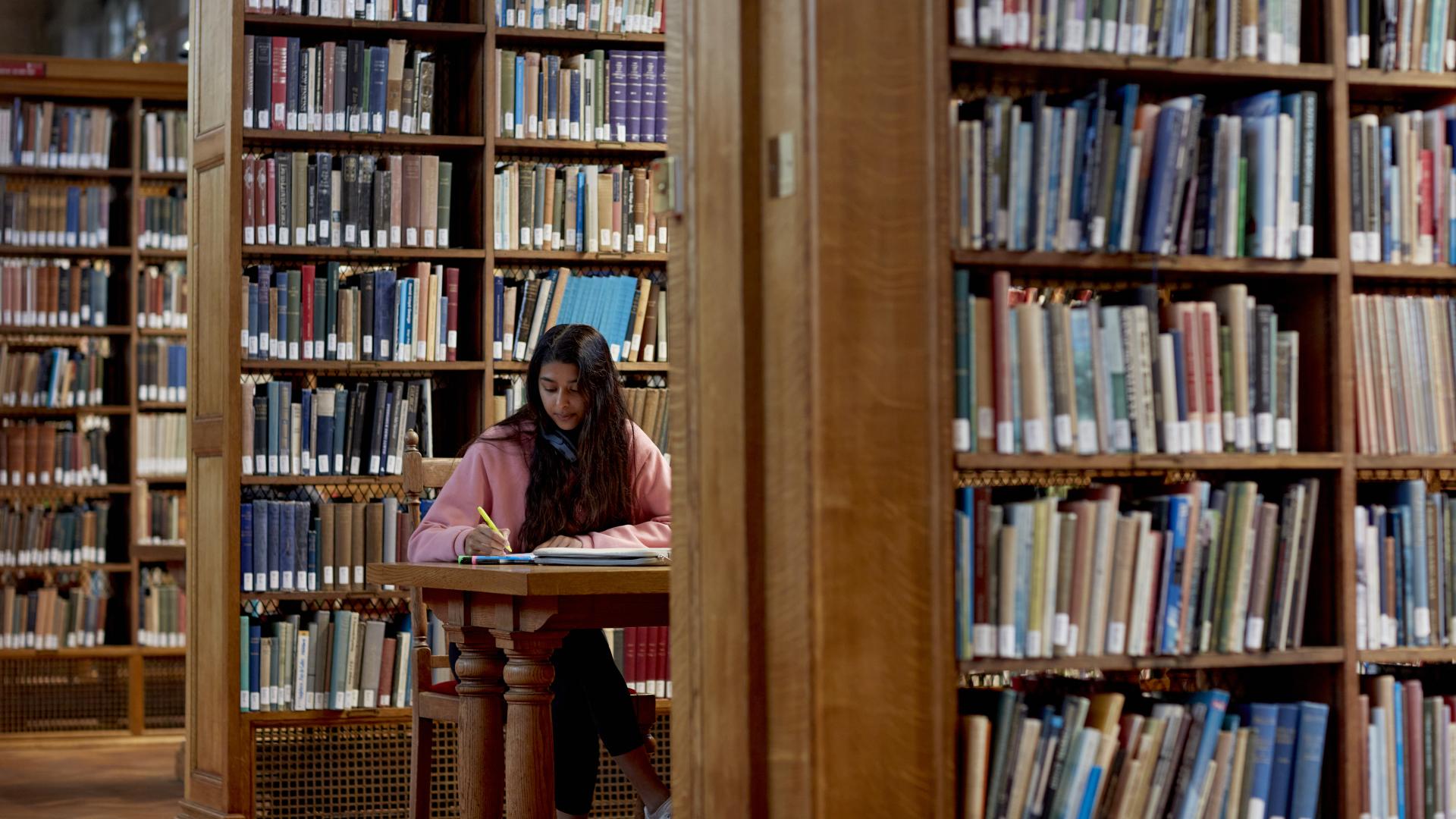 Student working in Bangor University Library