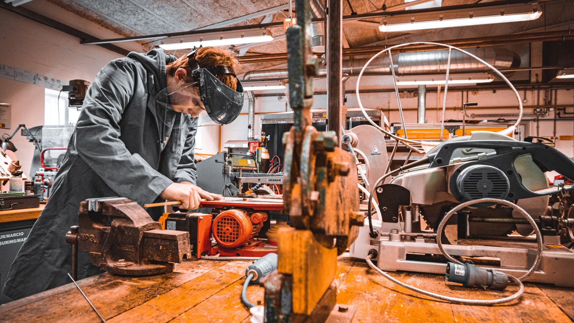 Product design student using a Hegner saw in the workshop