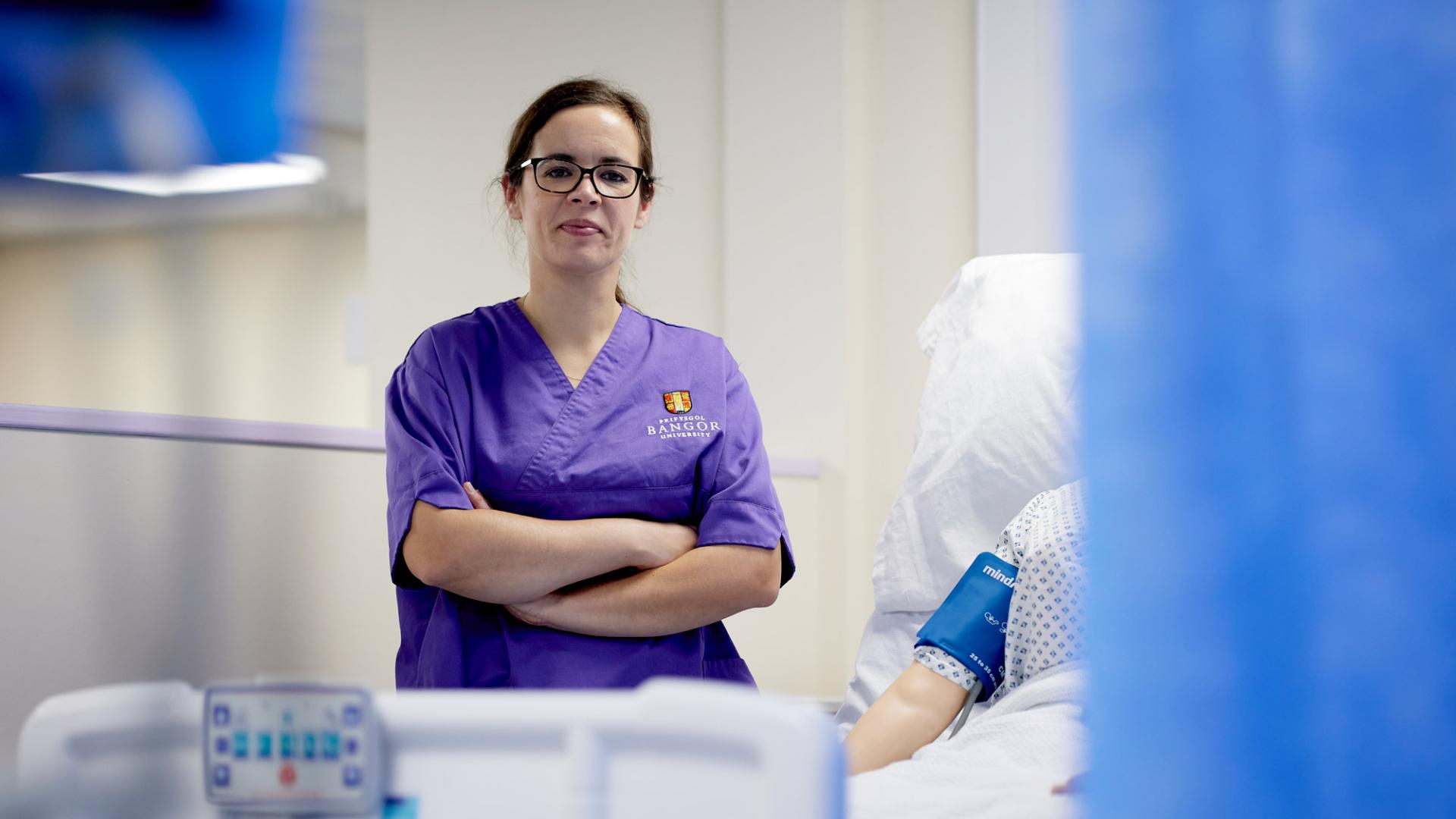 Adult nursing student in Bangor University apron