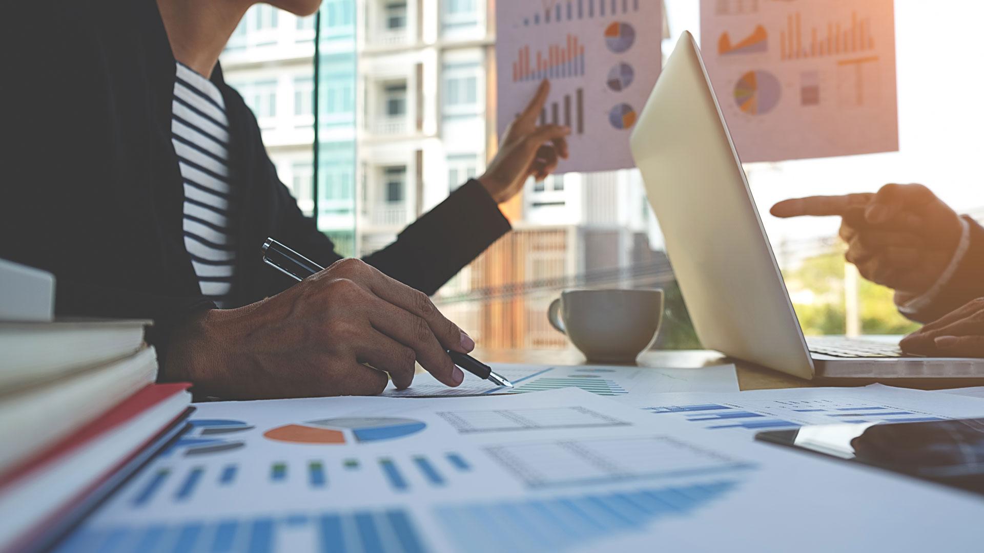 Office worker surrounded by financial charts