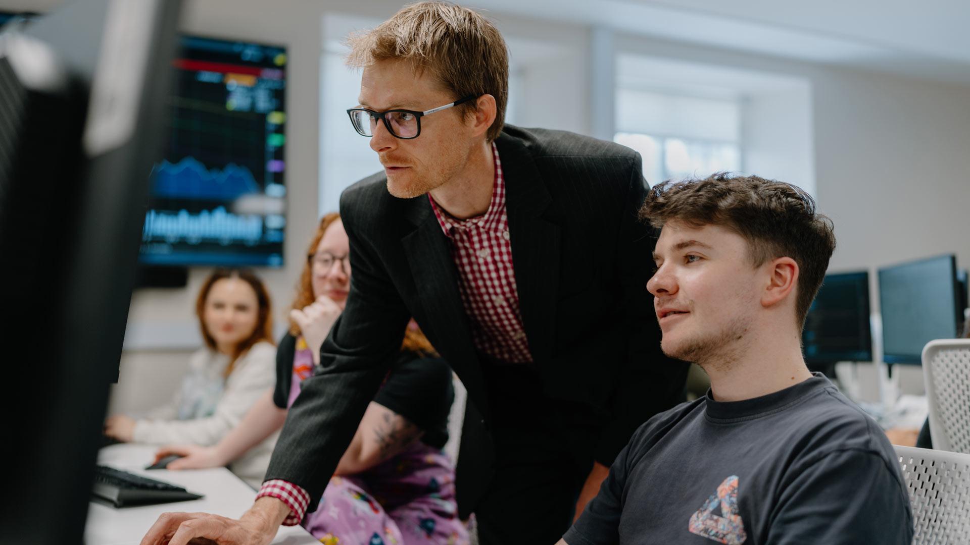 lecturer teaching students in computer lab