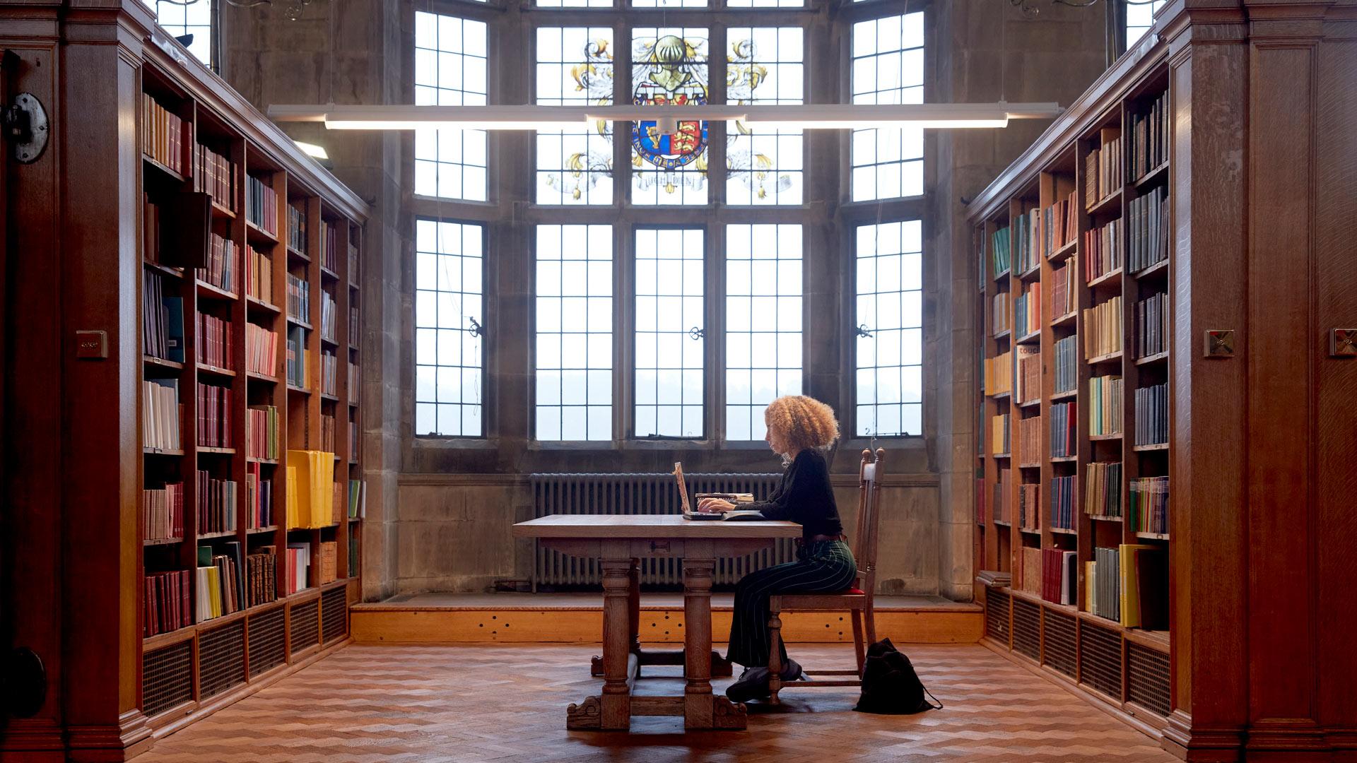 student studying in university library