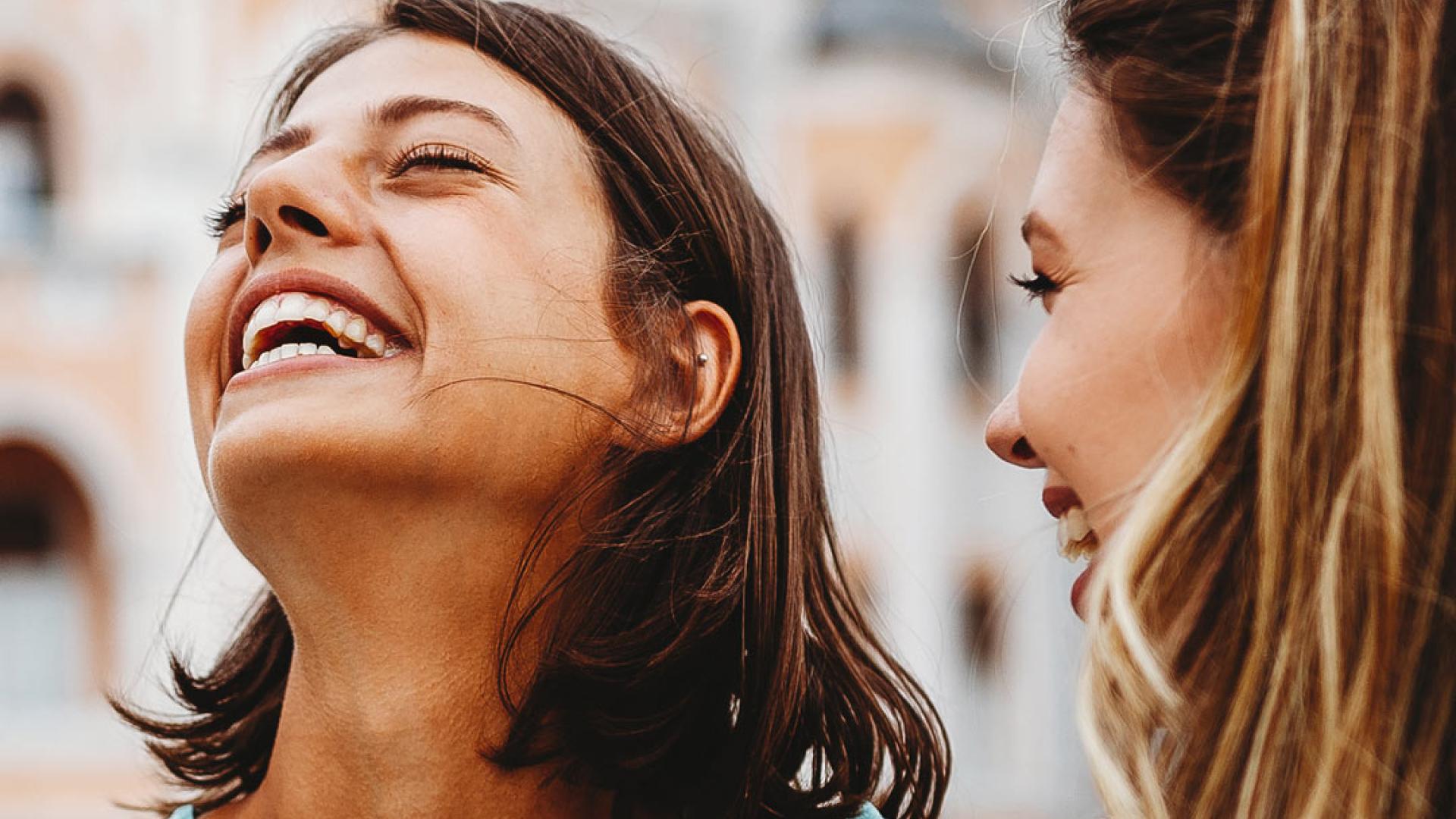 Tourists laughing whilst holding a map