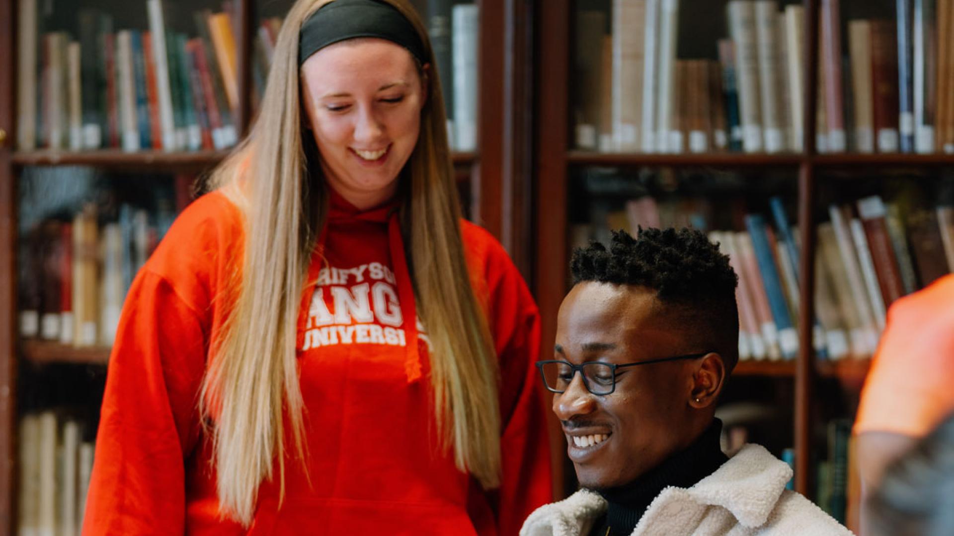 Students studying history books in library