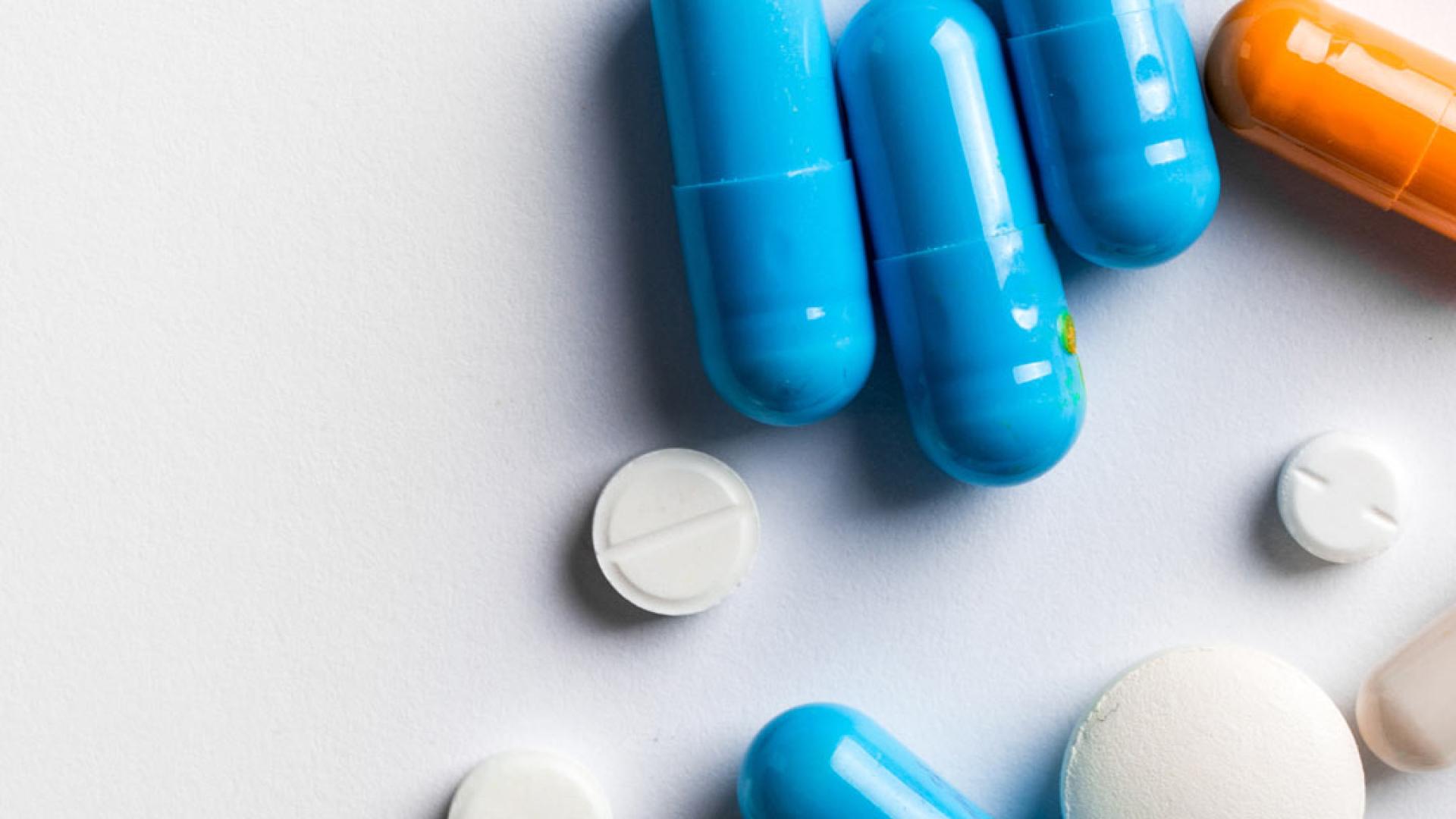 Multi coloured tablets on a grey table