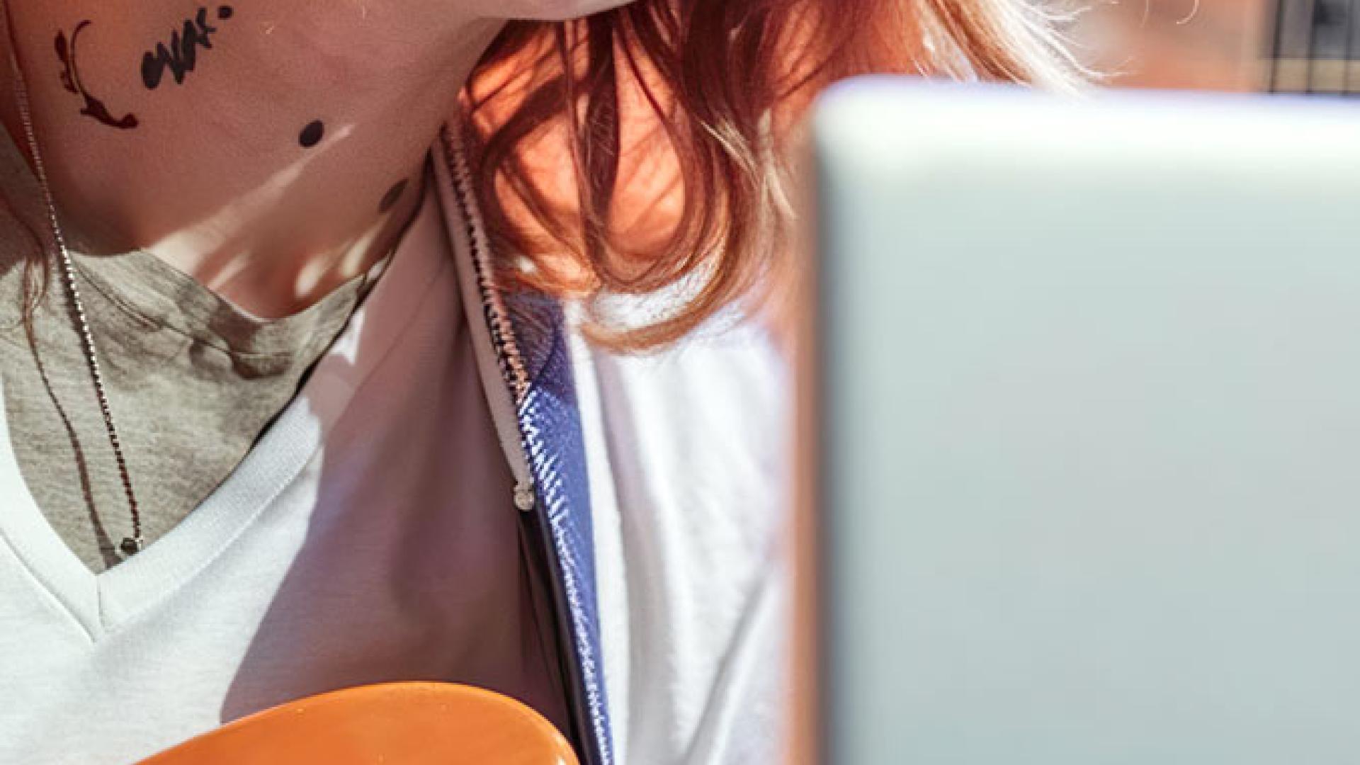 Girl with tattoos playing guitar