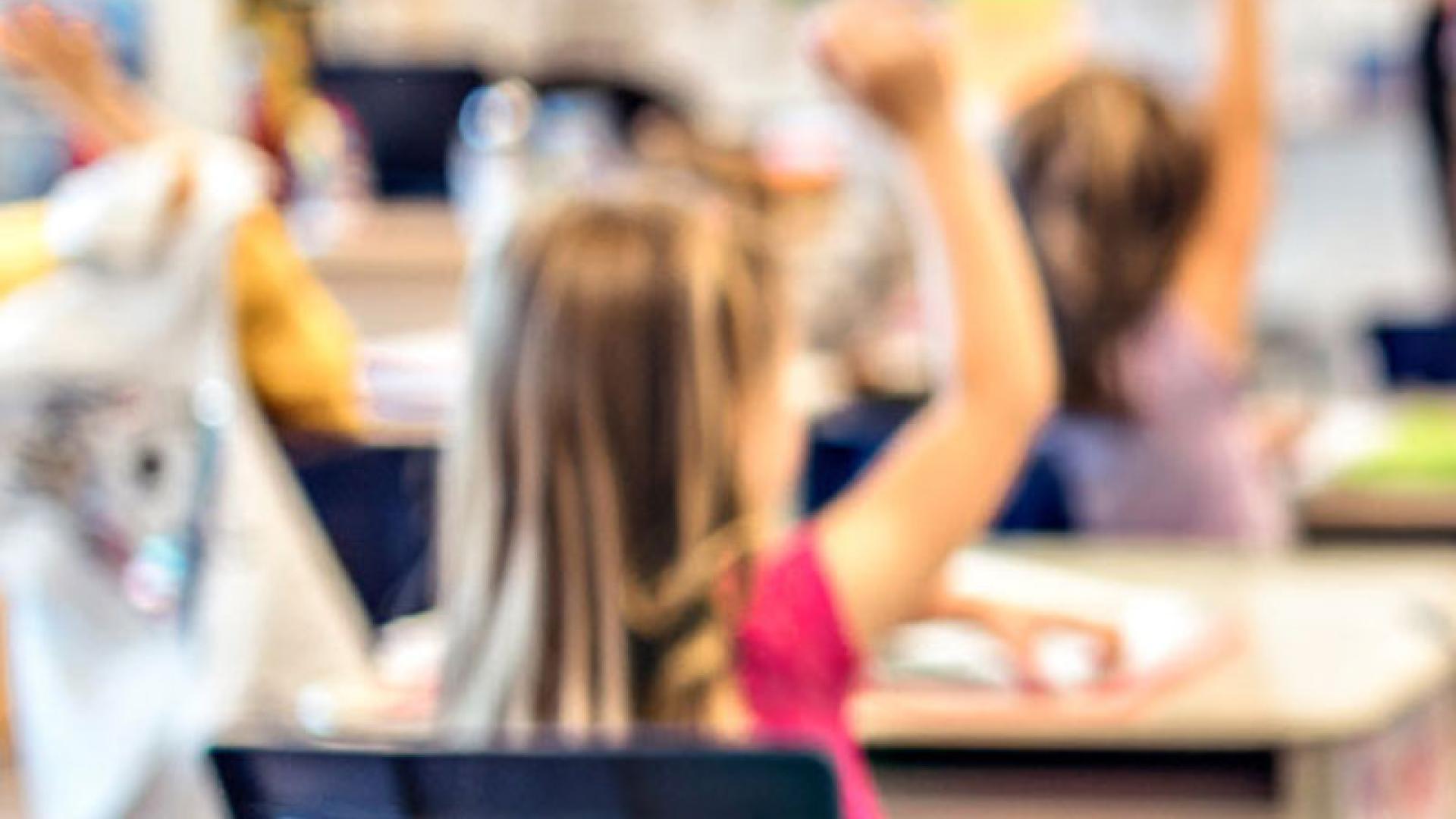 Child hand up in classroom