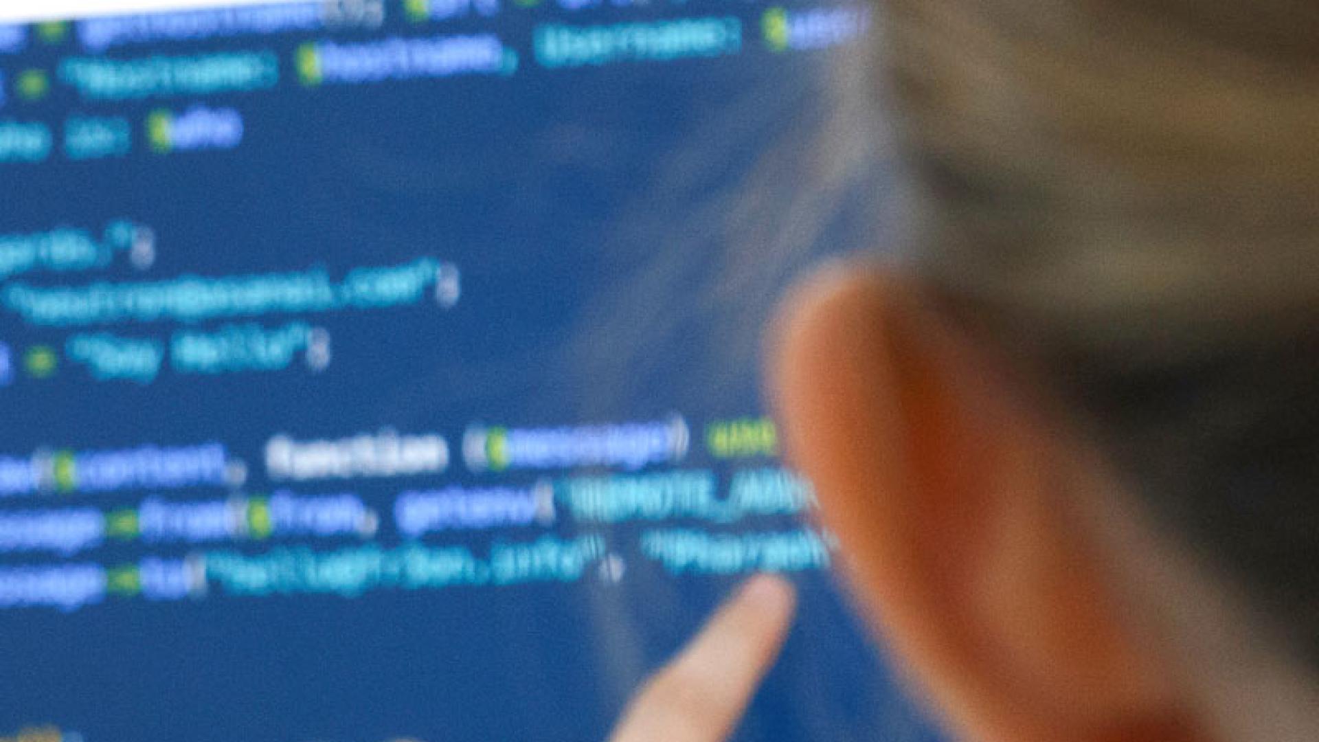 student looking at computer code