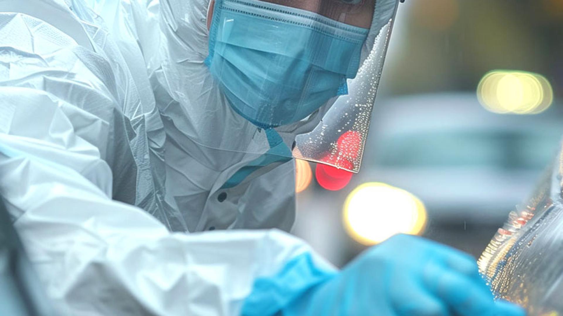 Criminologist in protective clothing collecting samples