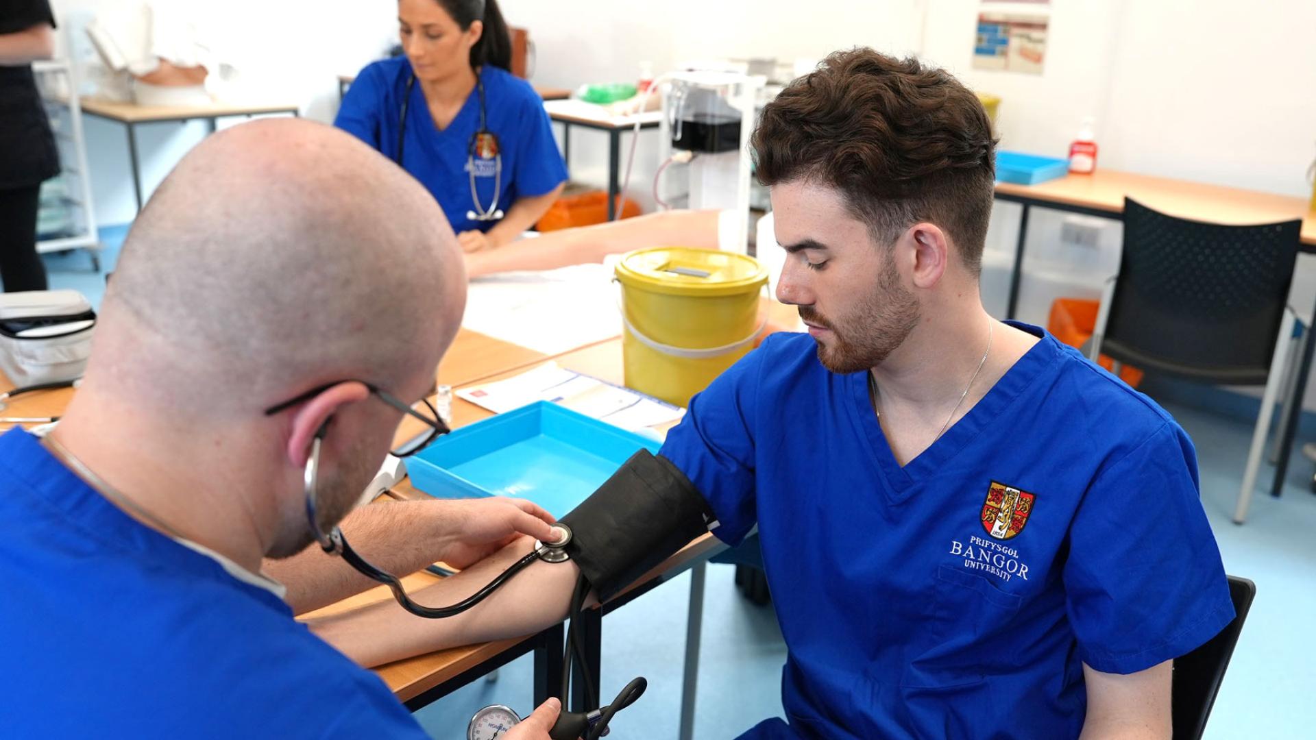 Student having blood pressure checked