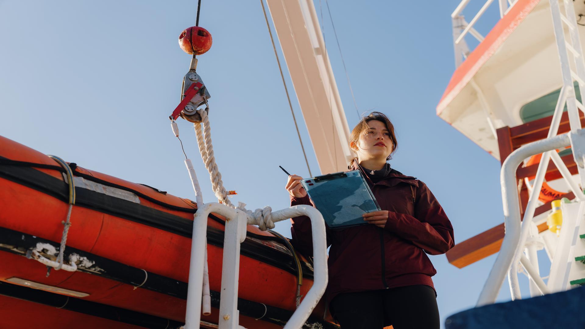 Student on a boat doing research