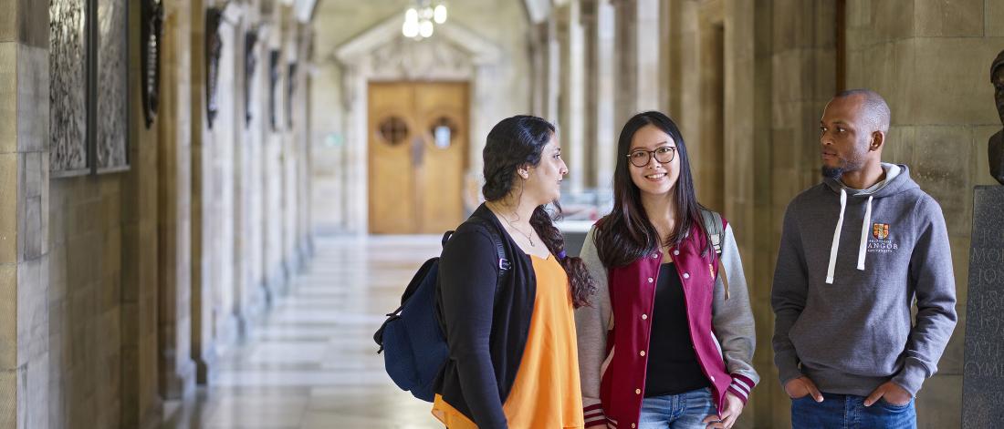 Students walking through a corridor at the Main Arts Building