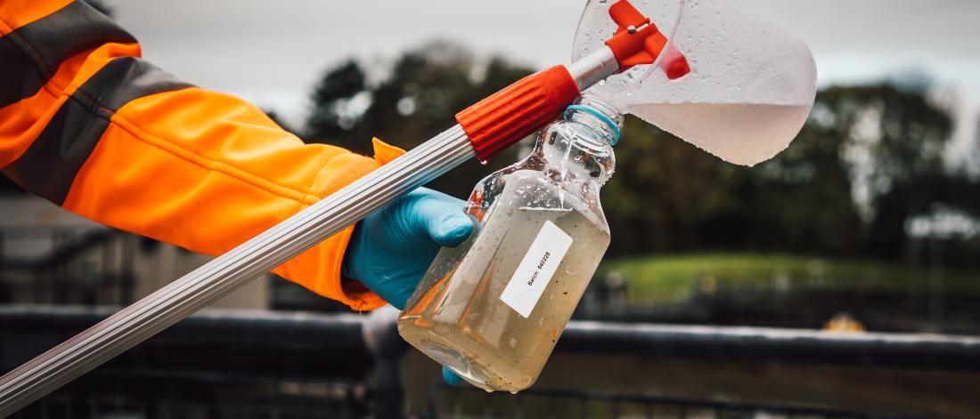 A member of staff tests waste water at a sewage plant