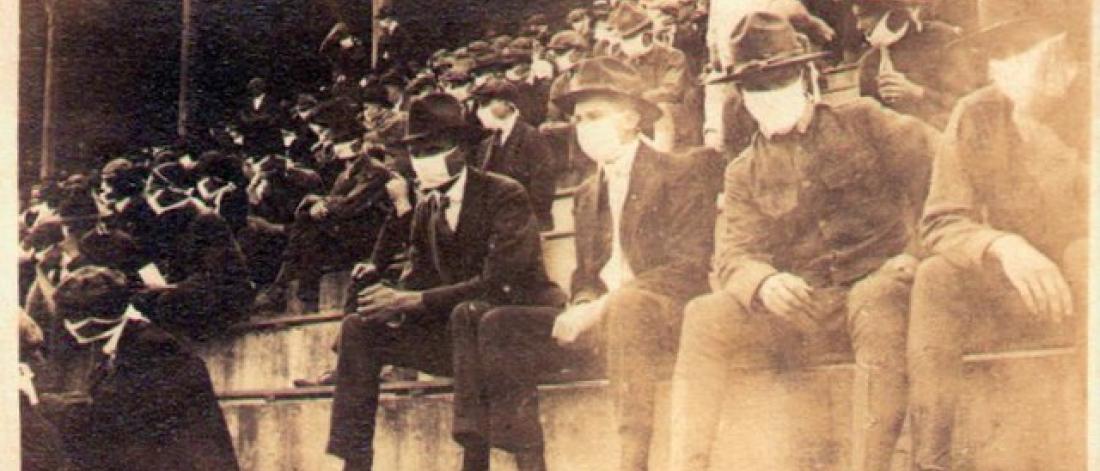 Historic image of crowd in football game 1918 wearing masks