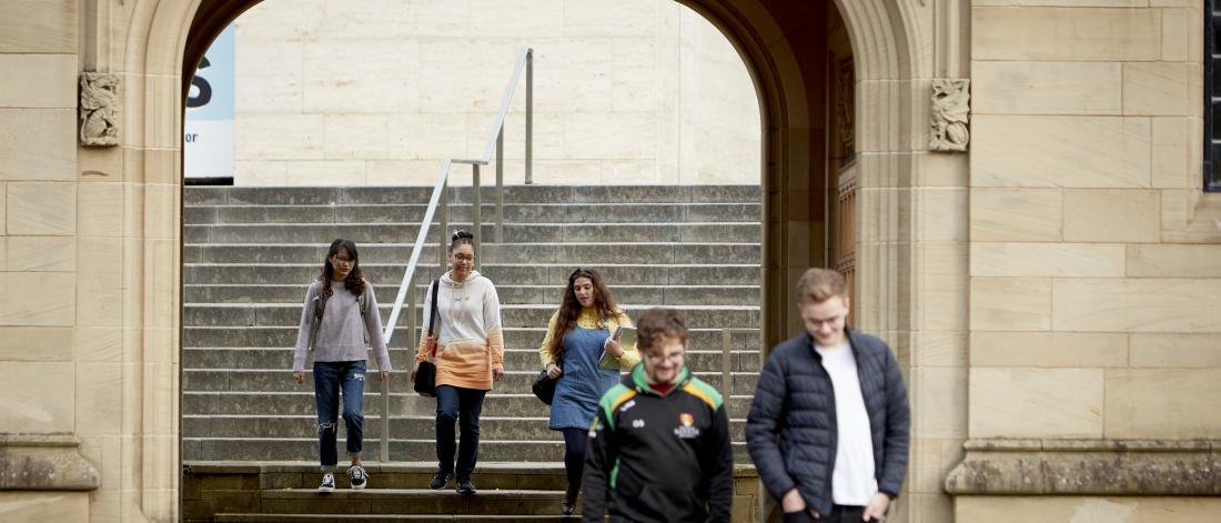 Students walking from Pontio through Memorial Arch